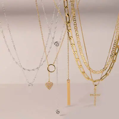 Collection of gold and silver necklaces with pendants, showcasing women's necklace jewelry.